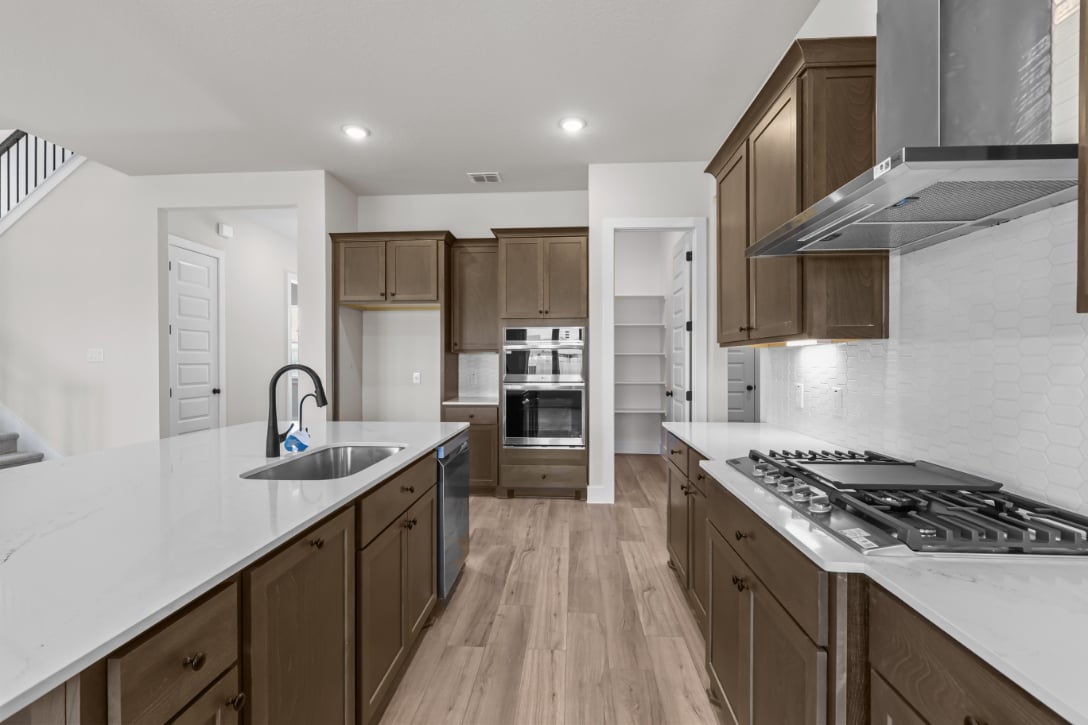 A kitchen with wooden cabinets.