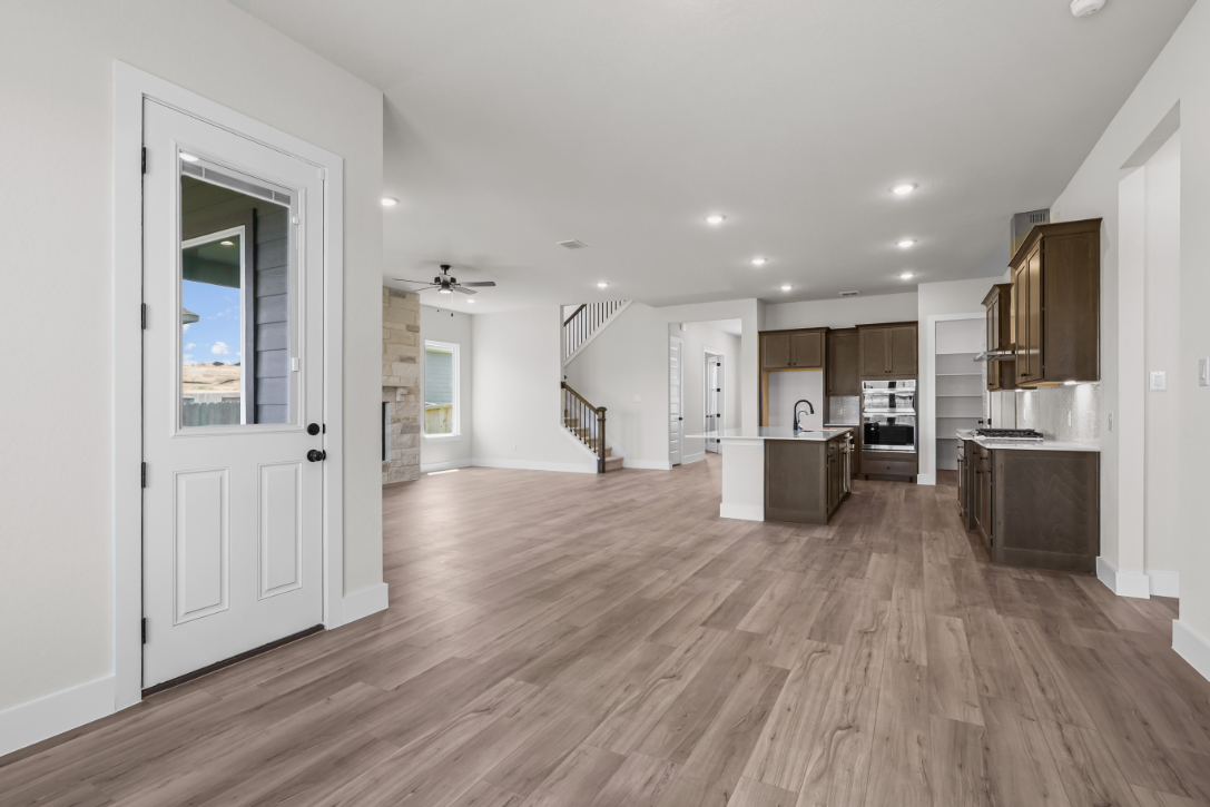 A large kitchen with wood floors.