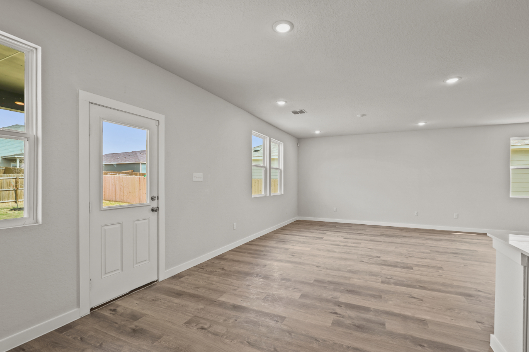 A room with a wood floor and white walls.