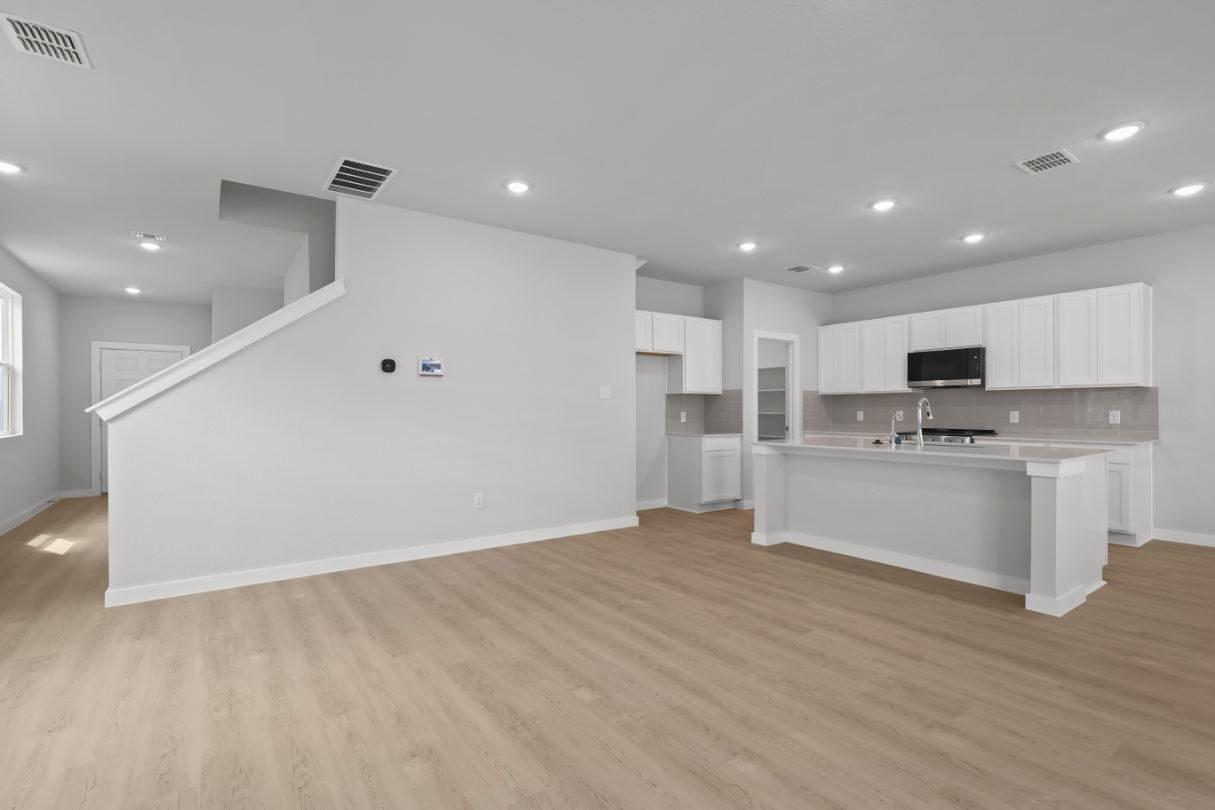 A large kitchen with white cabinets.