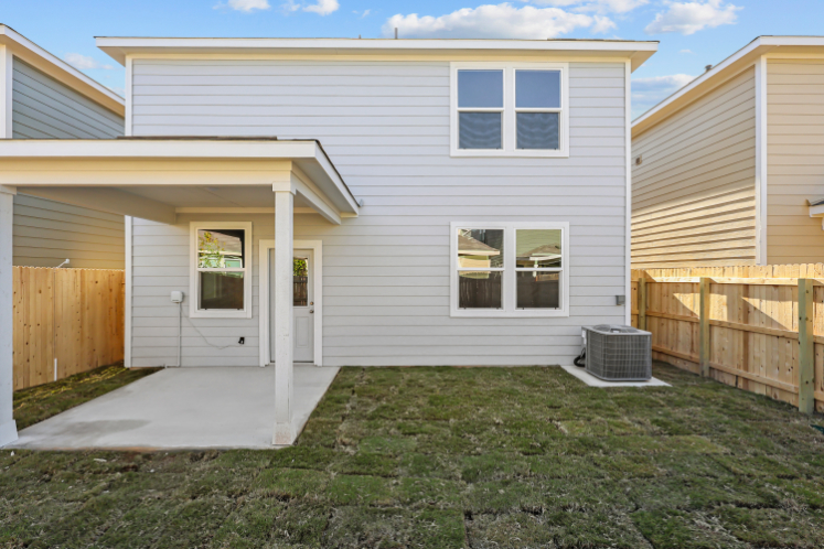 A house with a fence and grass.