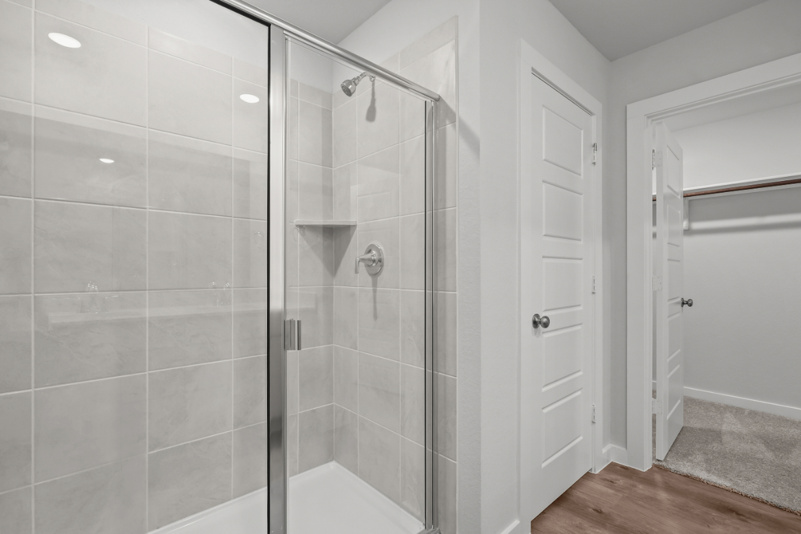 A shower with a glass door.