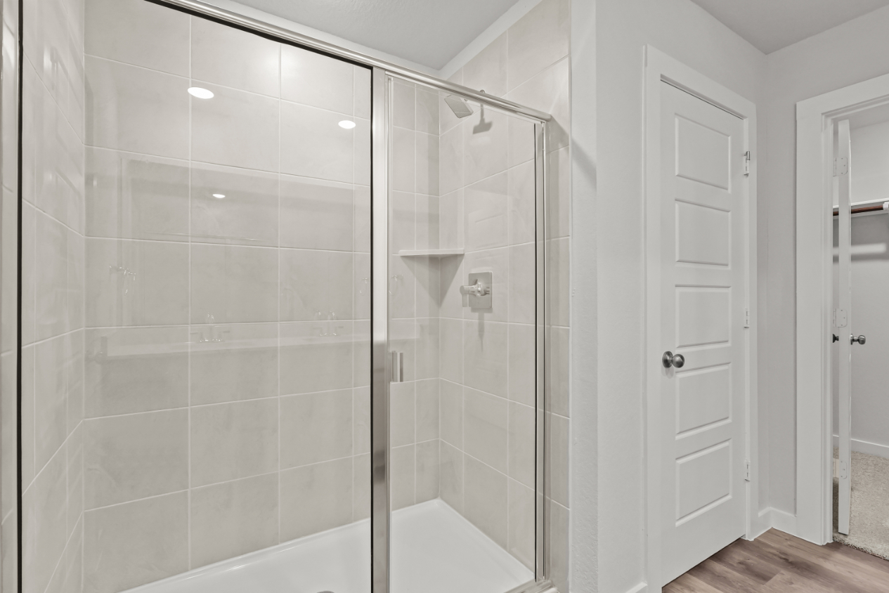 A shower with glass doors.