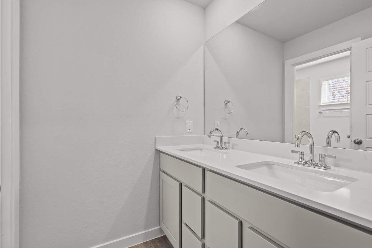 A bathroom with a large mirror.