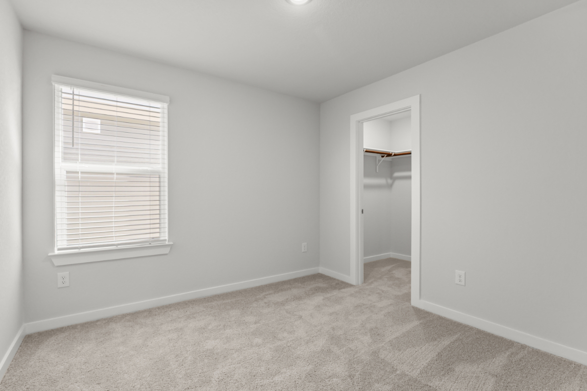 A room with a shelf and a window.