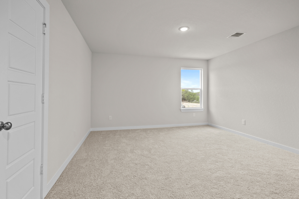 A room with a window and carpet.