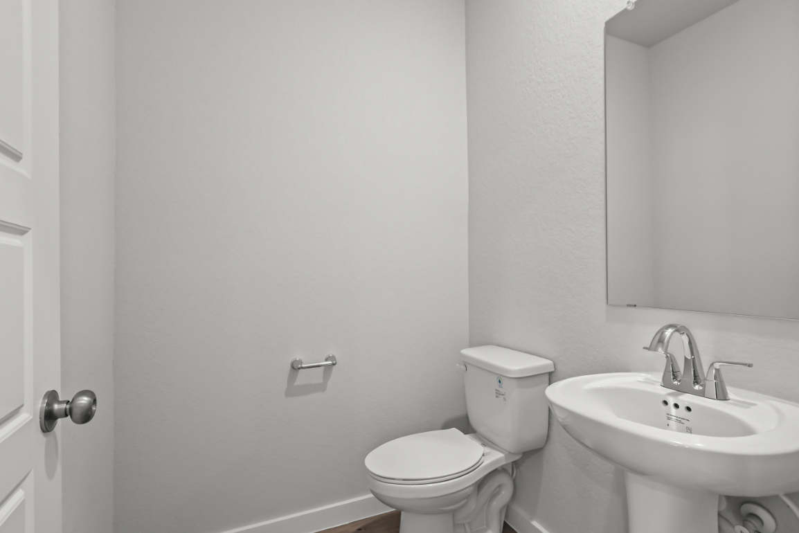 A bathroom with a toilet and sink.