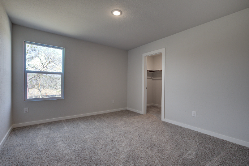 A room with a window and a door.