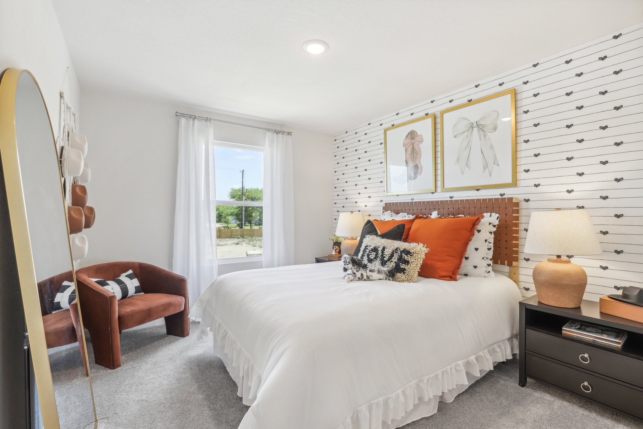 A bedroom with a bed and a chair.