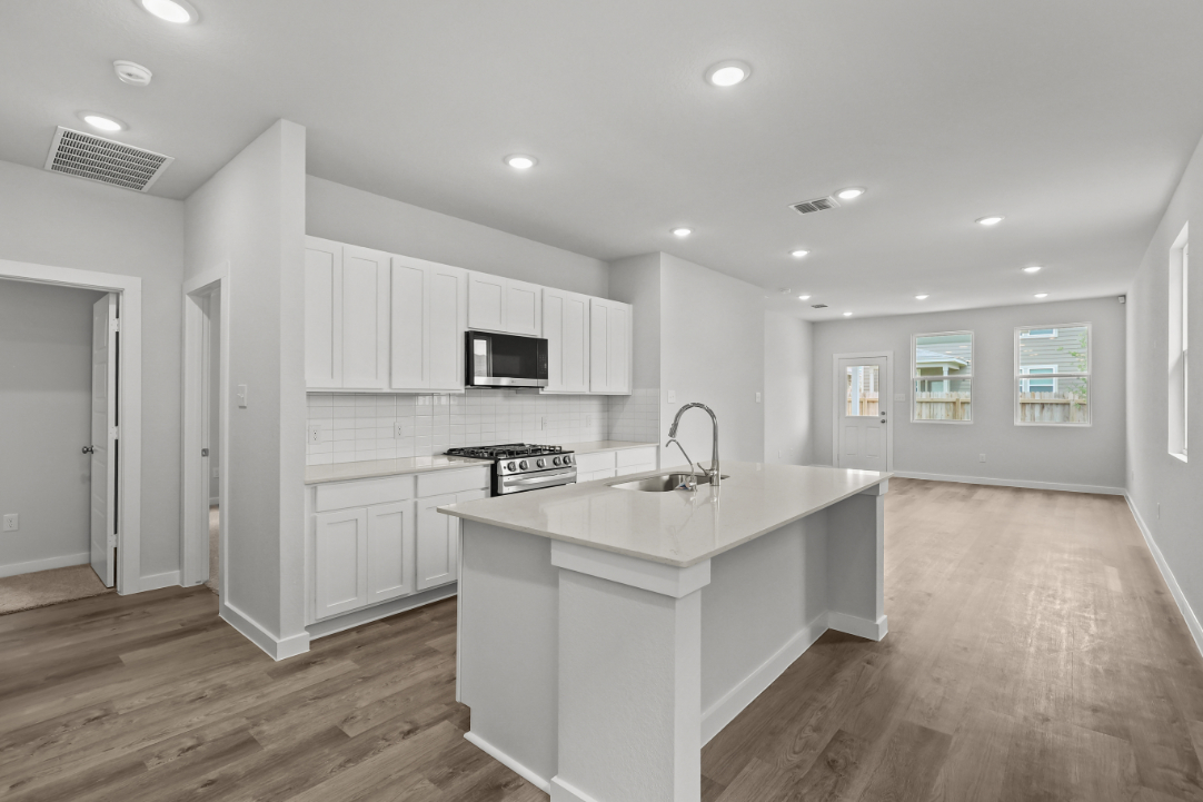 A kitchen with white cabinets.