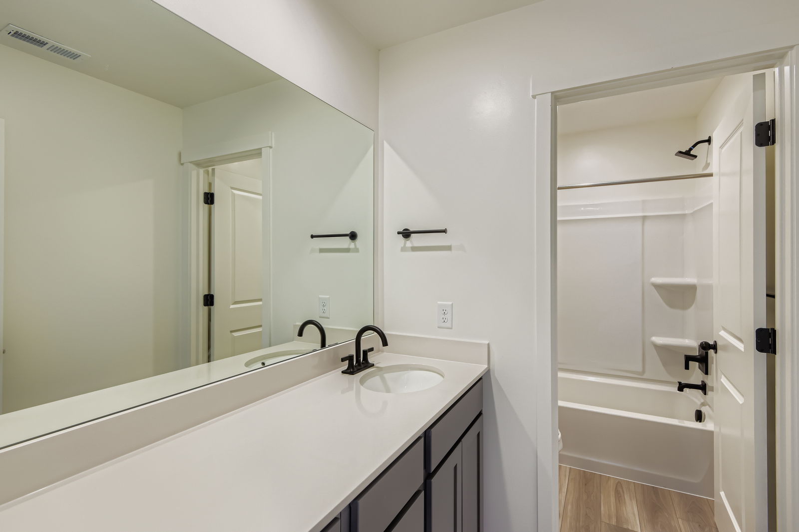 A bathroom with a large mirror.