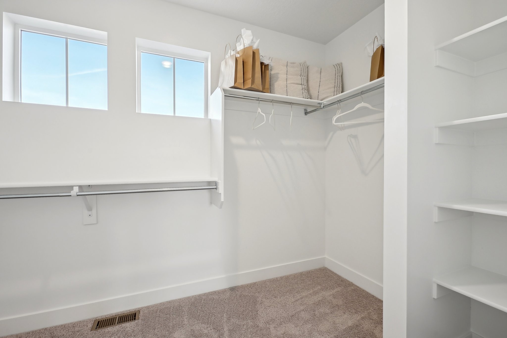 A bathroom with a shelf and towels.