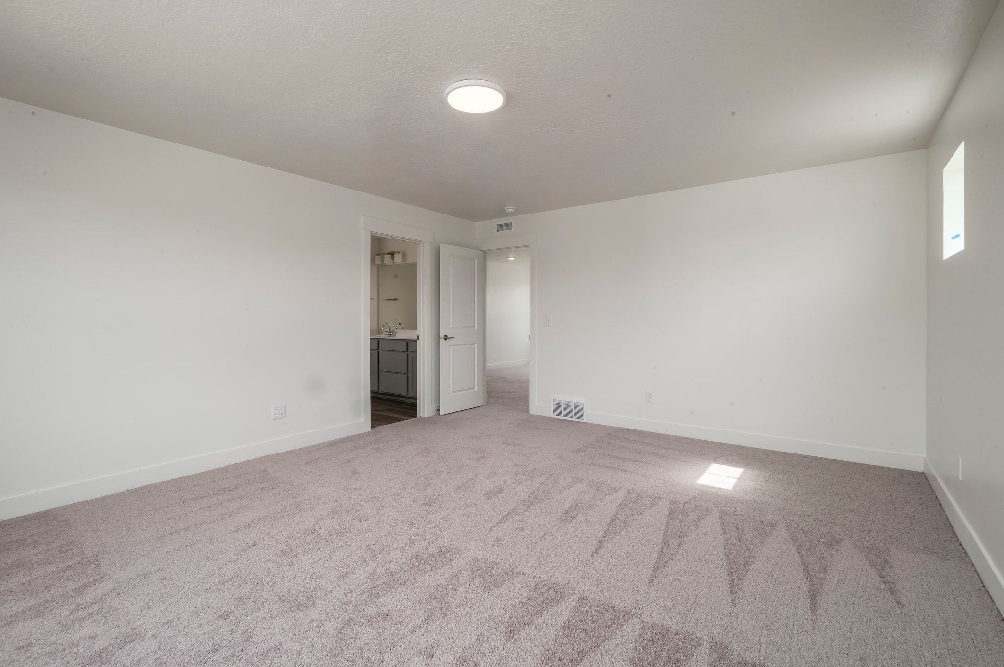 A long hallway with white walls.