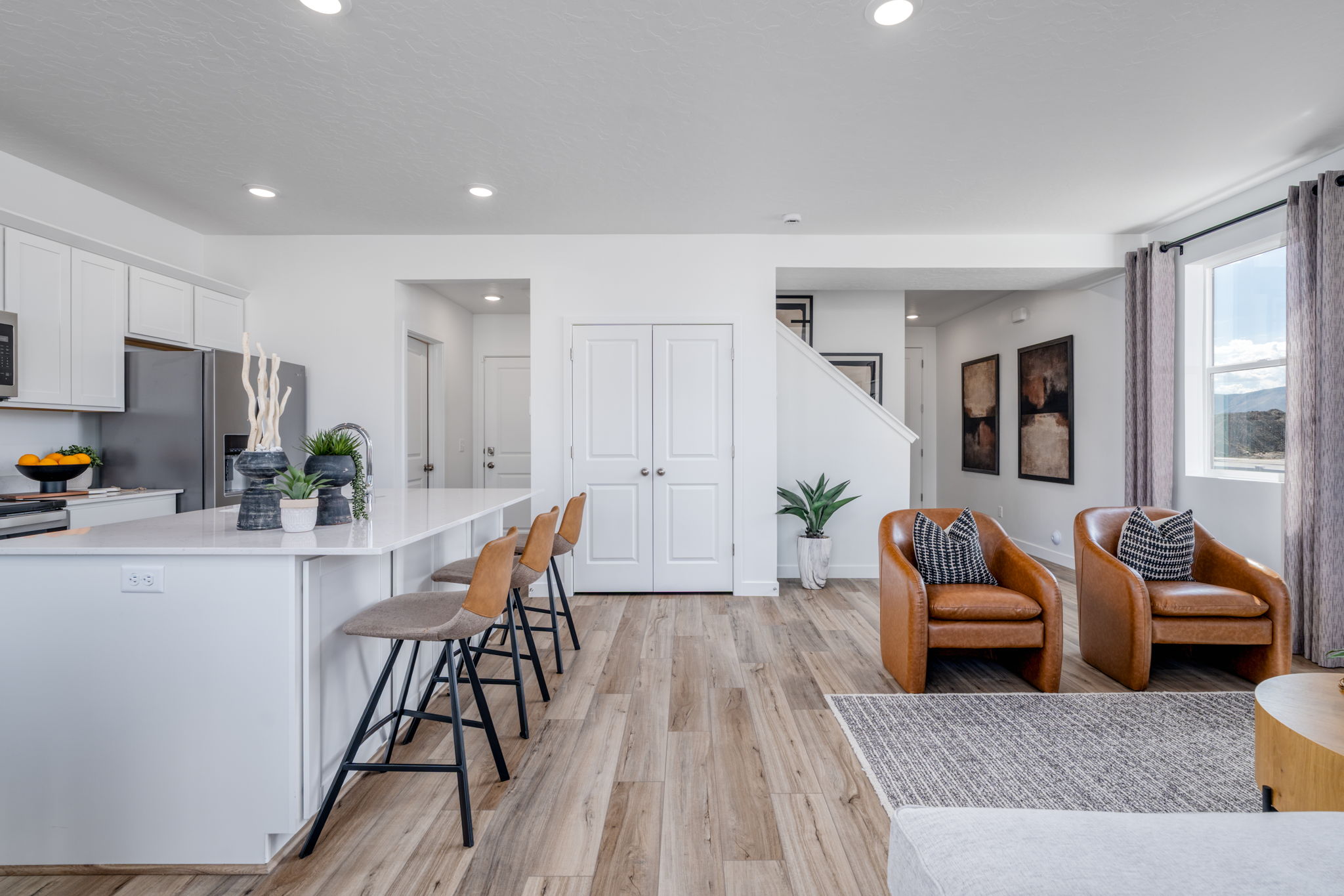 A kitchen with a dining table and chairs.