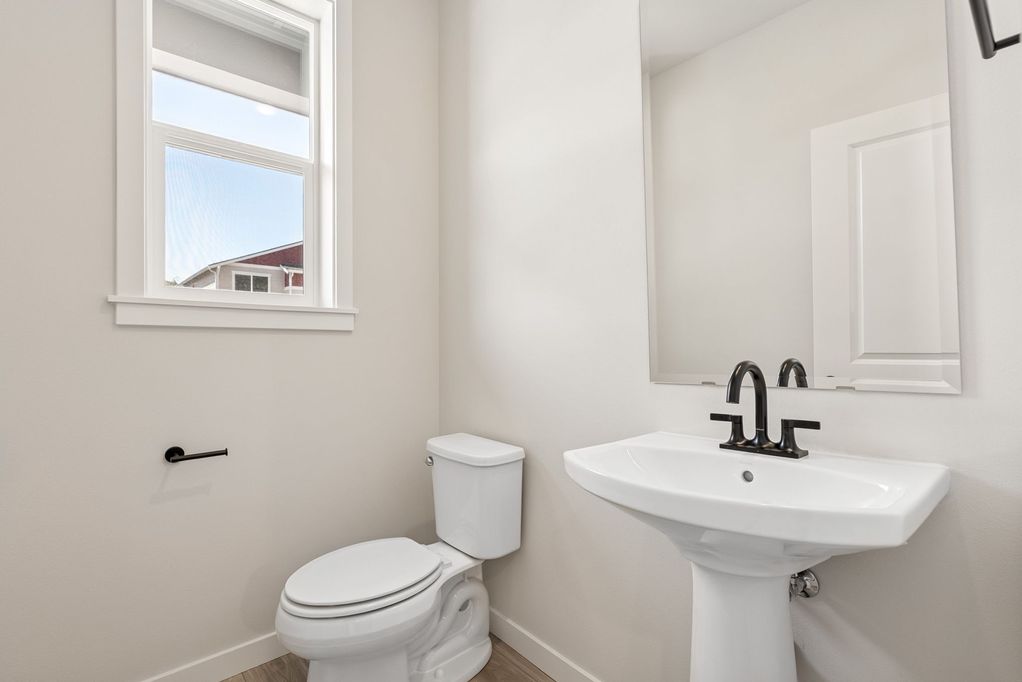 A bathroom with a toilet and sink.