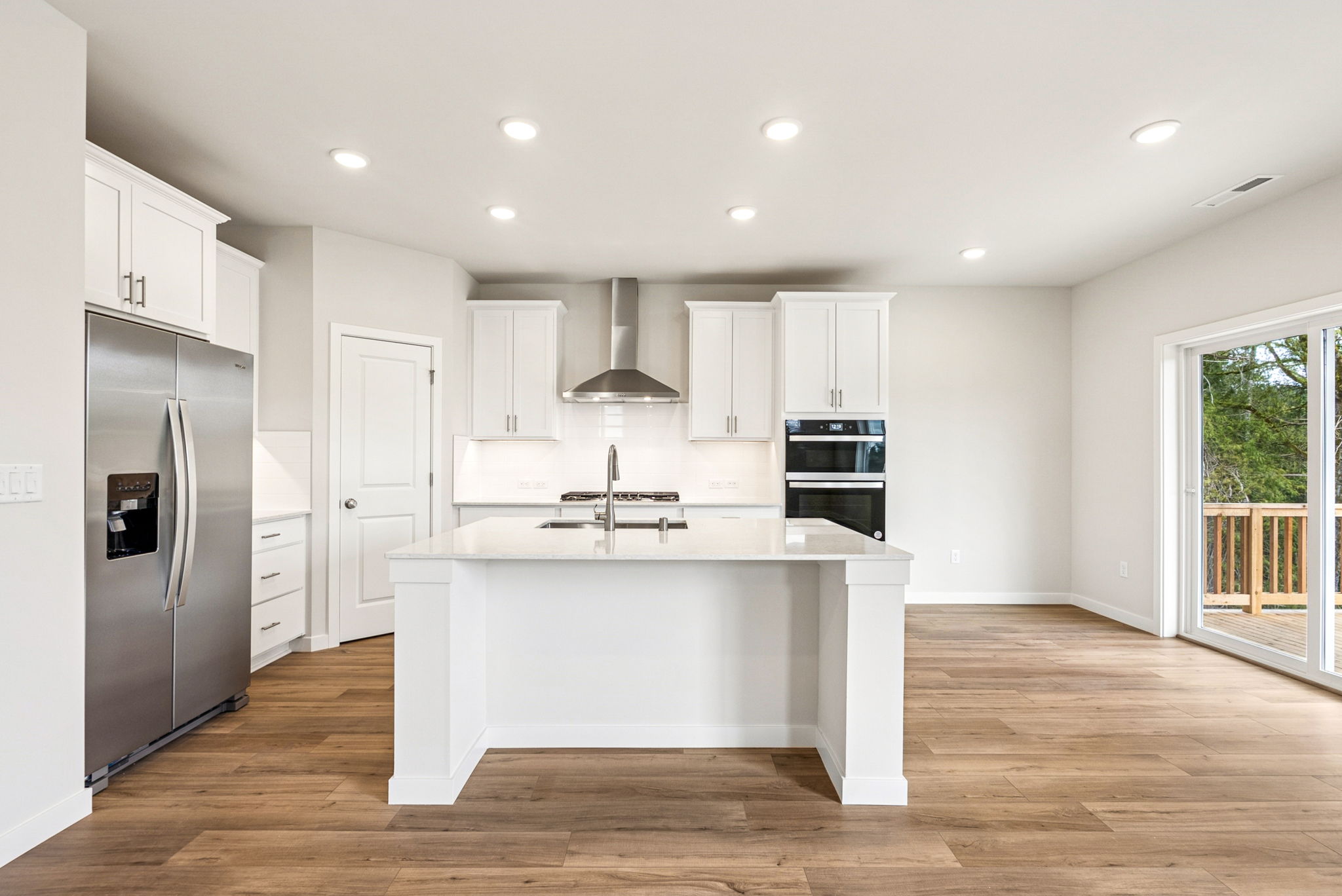A kitchen with white cabinets.