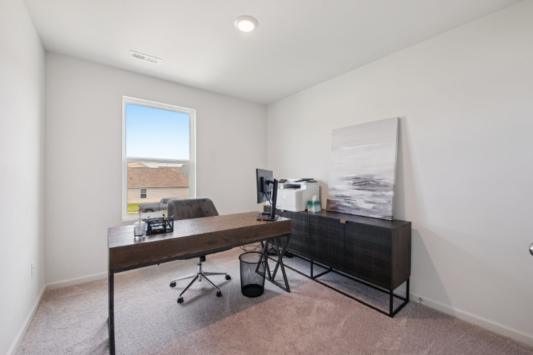 A room with a desk and a chair.