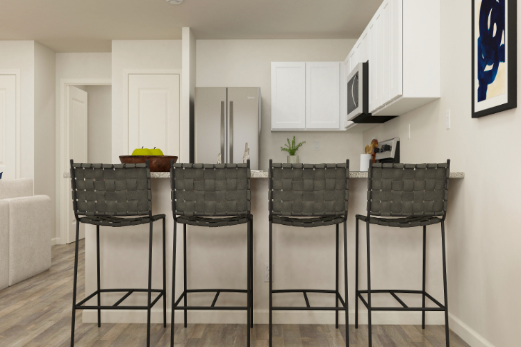 A kitchen with a table and chairs.