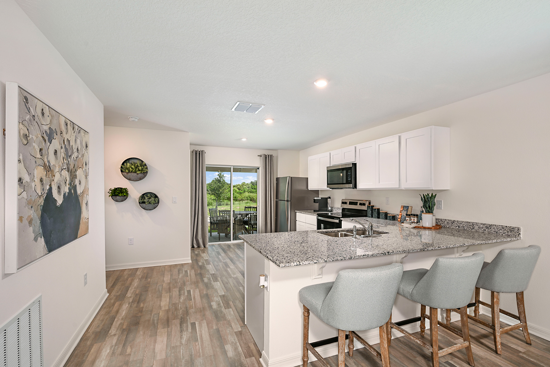 A kitchen with white cabinets.