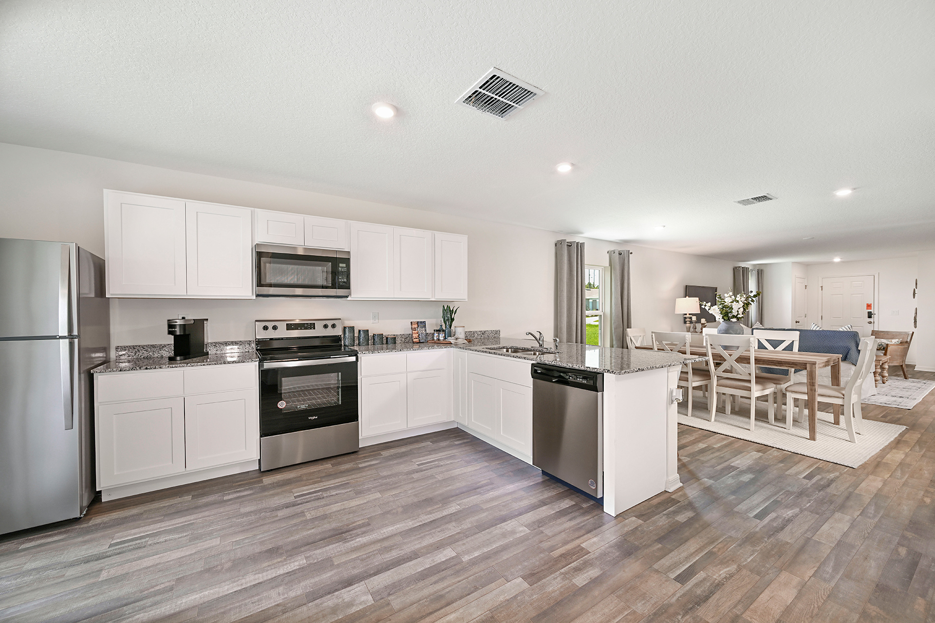 A kitchen with white cabinets.