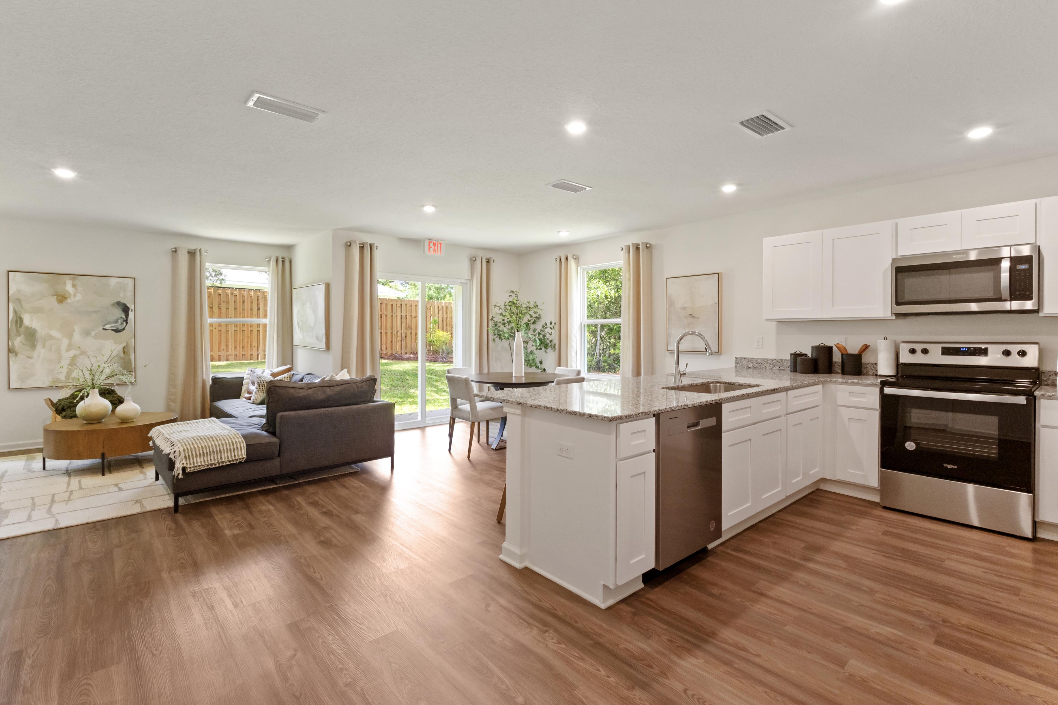 A large kitchen with a couch and a table.