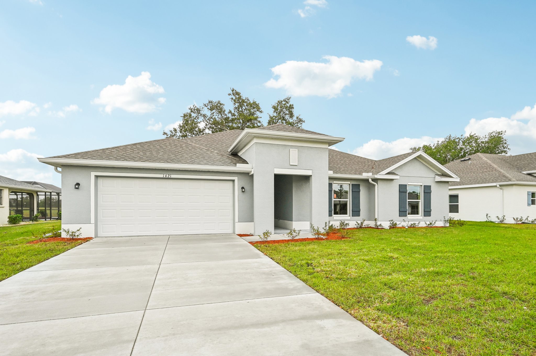 A white house with a driveway.