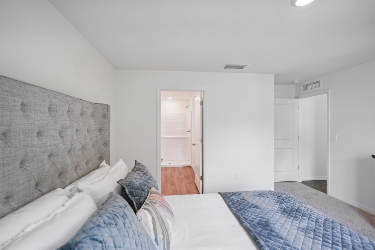 A room with a bed and a door.