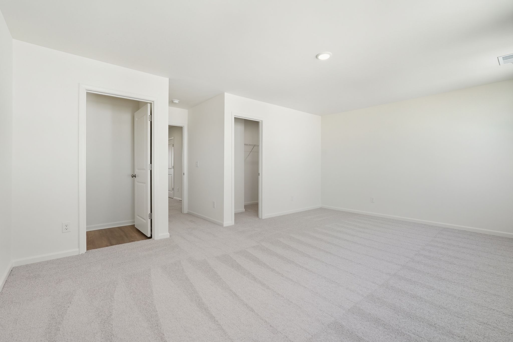 A long hallway with white walls.