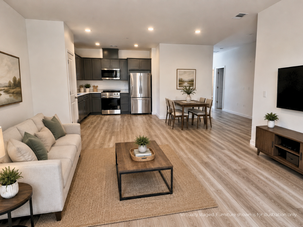 A living room with a large dining table and a large kitchen.